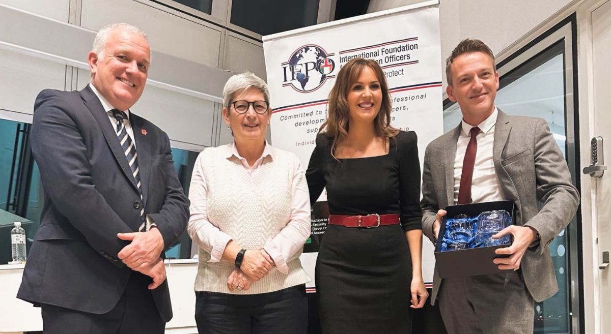 Ross Harvey holding his award with 3 people to his left